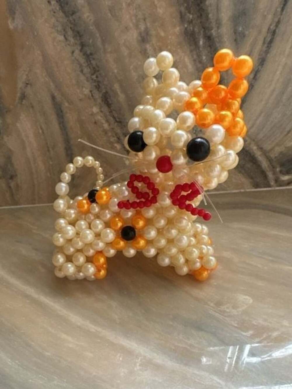 Handmade Beaded Pearl Cat Figurine with Orange and White Design